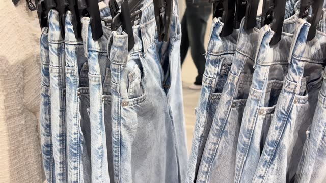 Sale assortment denim collection stand in boutique shop 4k stock video