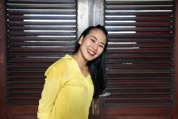 portrait asian woman  next to wall