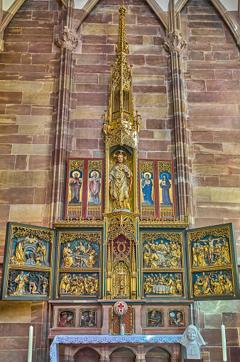 Strasbourg, France- September 22, 2022:  A golden altarpiece inside the gotic Cathedrak of Our Lady