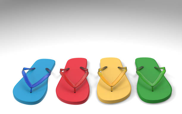 Blue, red, yellow, green flip flops on a light gray background with copy space,