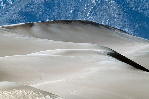 Footprints in huge sand dunes in Great Sand Dunes National Park in Colorado in western USA, North America.