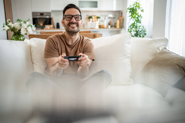istock Smiling middle-aged man playing video games 2148613648