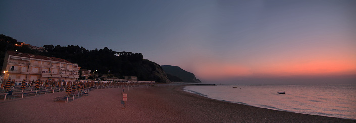 Conero beach and sea horizon photographed during sunrise. Marche, Italy.