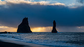 Rocky peaks in front of a dramatic morning sky at Black Beach, Iceland