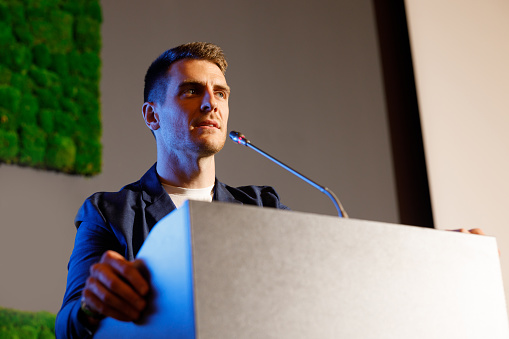 A man giving a speech at a business technology conference