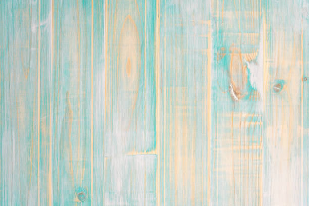 Joined wooden planks with a very marked grain and worn turquoise color. View of weathered wood on turquoise planks with visible grain giving worn stripped feel green painted wood texture stock pictures, royalty-free photos & images