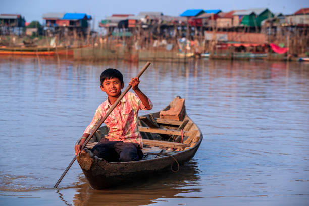 istock Cambodian young boy rowing a boat, Tonle Sap, Cambodia 2148615547