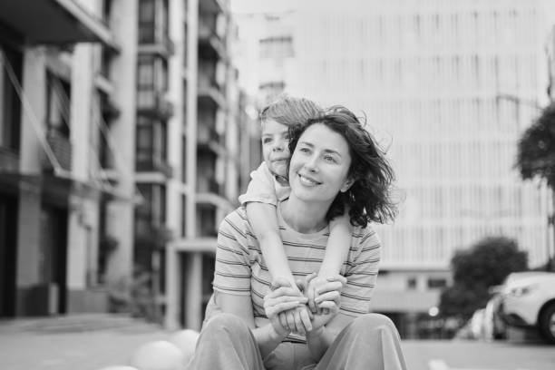 istock Young mother and son smiling looking at camera in modern residential complex 2148617273