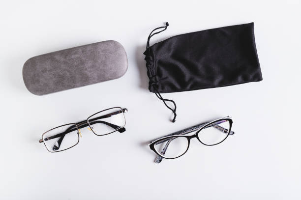 istock Eyeglasses, hard and soft storage case on blue background top view 2148617278