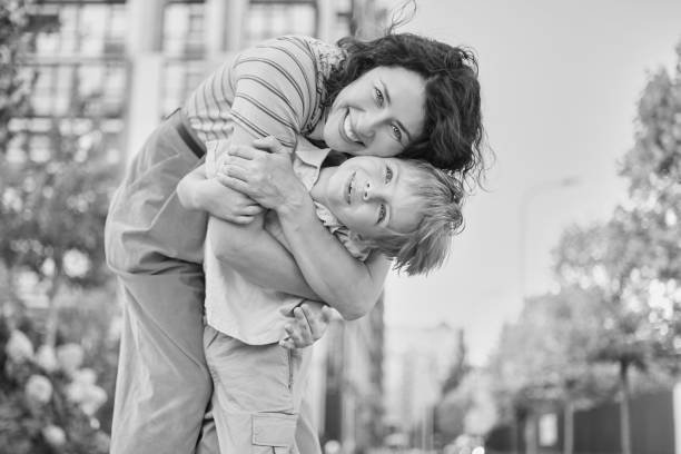 istock Young mother and son smiling looking at camera in modern residential complex 2148617310