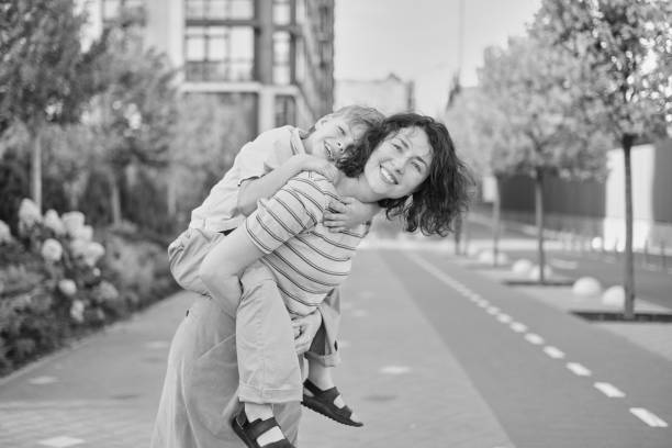 istock Young mother and son smiling looking at camera in modern residential complex 2148617423