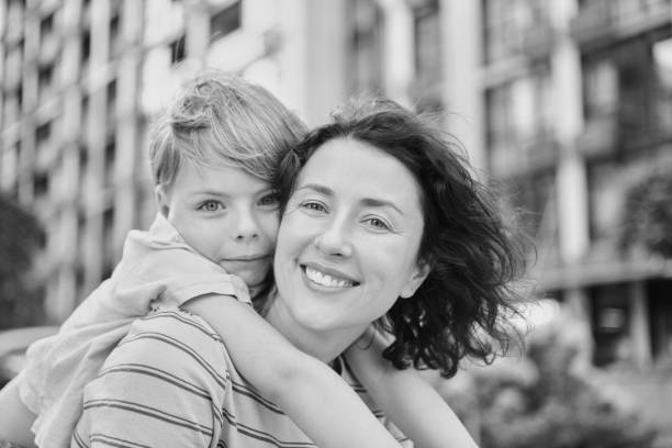 istock Young mother and son smiling looking at camera in modern residential complex 2148617593
