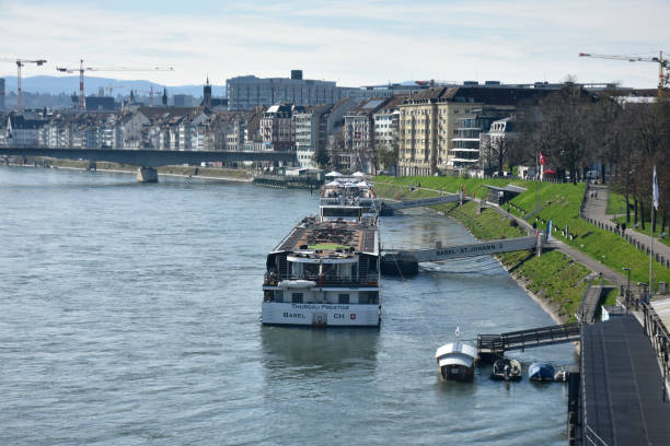 Basel, Switzerland - March 22, 2024: Basel Recreational Cruise Ship Docked On River Rhine In Basel Switzerland Europe, Building Exterior, Land Vehicle, People Scene During Springtime