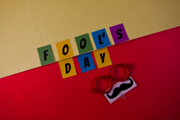 istock Fools day text on red and yellow background top view 2148620966