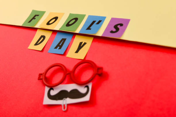 Happy Fools Day text on colourful sticky notes with mustache and glasses