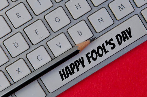 A humorous close-up photo of a crisp white computer keyboard with the message Happy April Fool's Day cleverly typed on the spacebar key