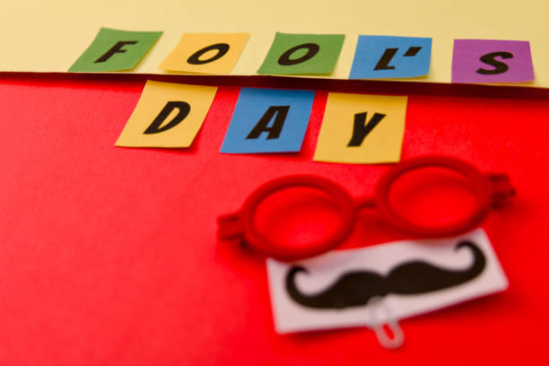 istock fools day concept with letters and glasses on a red background 2148620987