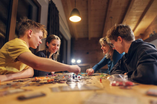 Family playing large modern board game together at home