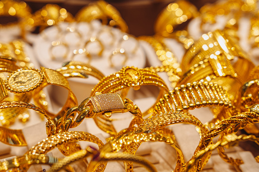 Atique golden bracelets for woman close-up. Jewelry market.