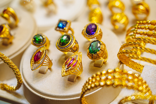 Large gold rings with precious stones.