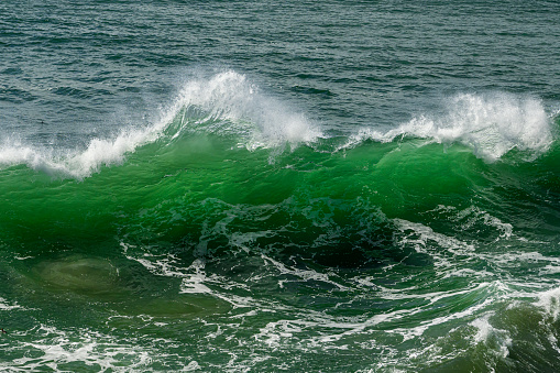 Wide view of ocean waves crashing along the Northern California Coast.\n\nTaken in Santa Cruz, California, USA