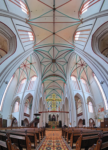 Schwerin, Germany - October 21, 2016: Vertical panorama of interior of Schwerin Cathedral. The cathedral dedicated to the Virgin Mary and Saint John the Evangelist was founded in the late 12th century. It is now the seat of the Bishop of the Evangelical Lutheran Church of Mecklenburg.