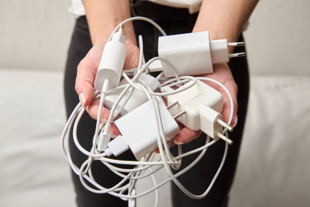 istock A woman holds multiple chargers in her hand for devices and chooses compatibility 2148627706