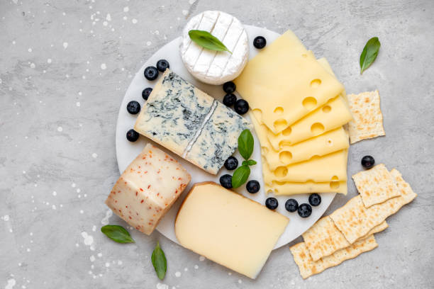 istock Cheese platter with craft cheese assortment on a marble platter. hard cheeses, mold cheese, gorgonzola, pecorino, Emmental, Roquefort 2148629123