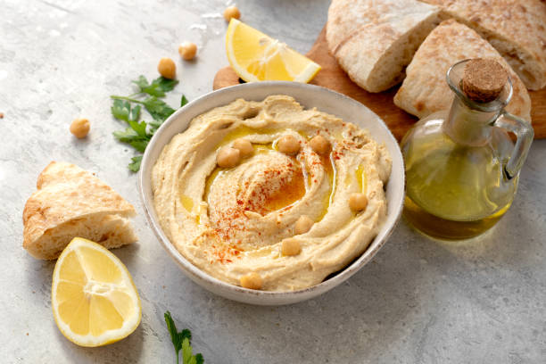 istock Hummus with chick pea olive oil and lemon  with multigrain crackers 2148629139