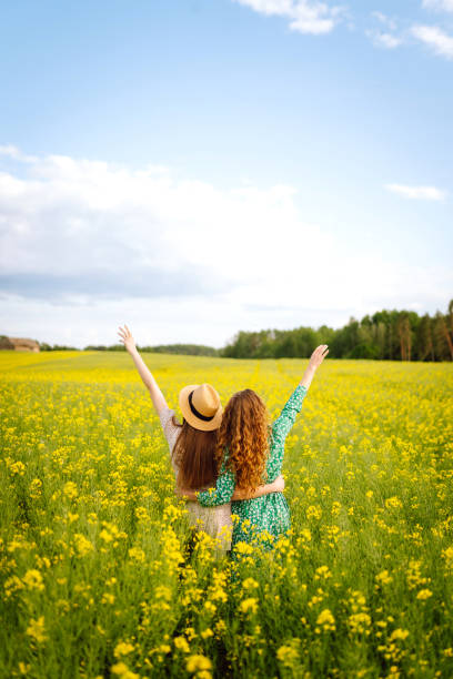 istock Two Beautiful women in the blooming field. 2148630001