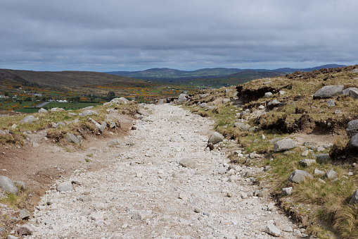 A stone country road disapperating off into the distance in the Mourne Mountains.