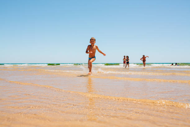 istock Children having fun in the ocean 2148630089