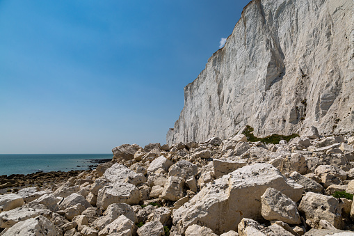 Chalk cliffs on the Sussex coast with a blue sky overhead