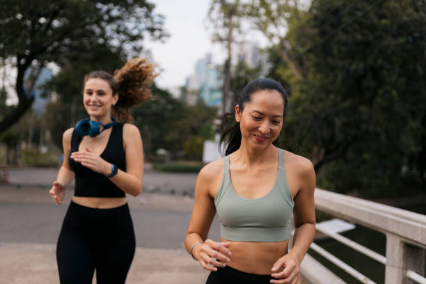 istock To young women doing running workout in park 2148633224