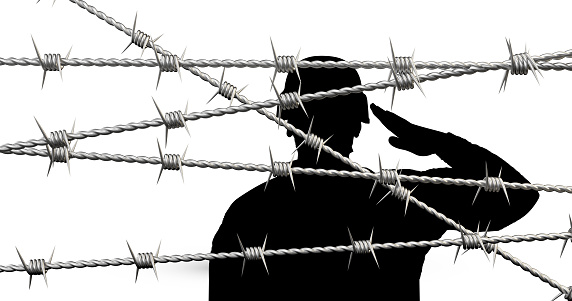 soldier silhouette behind barbed wire
