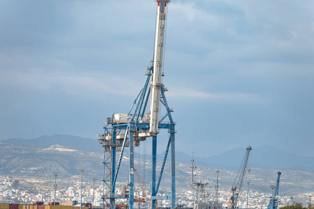Industrial cargo crane at Limassol port with a cloudy sky background. Cyprus