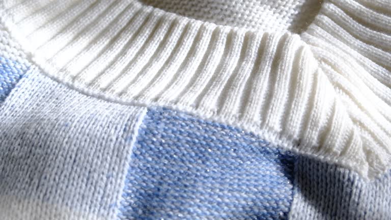 Blue and white color knitted fabric texture. Product from wool. Handwork, dress. Detailed warm yarn background.