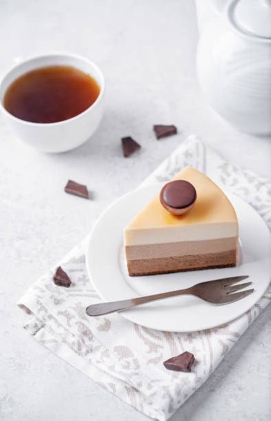 istock Three chocolate cake in a plate with cup of tea 2148636827