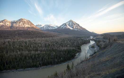 Late evening view of Matanuska River flowing  past Chugach Mountains near Palmer Alaska United States