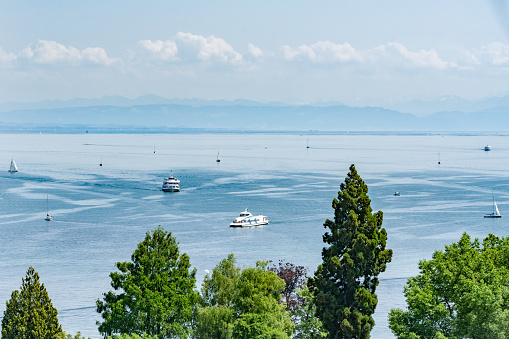 Description: View over the lake with excursion boats, catamaran ferry and sailing boats on a sunny summer day with alpine panorama. Constance, Lake Constance, Baden-Württemberg, Germany, Europe.