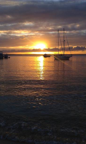 istock Boat in the horizon during a sunset 2148641359