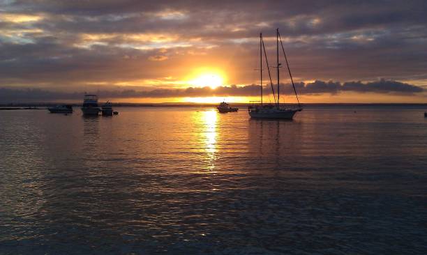 istock Boat in the horizon during a sunset 2148641489