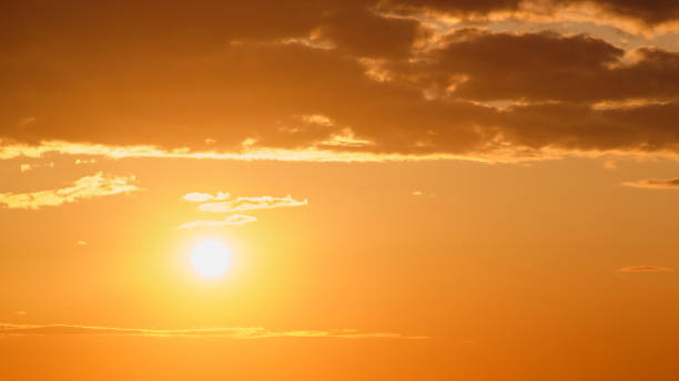 istock Sunset in the sky with clouds and rays of the setting sun 2148643253