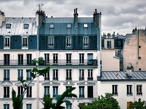 Paris, France - April 10 2023: classic haussmann architectural style typical parisian residential building with french balconies