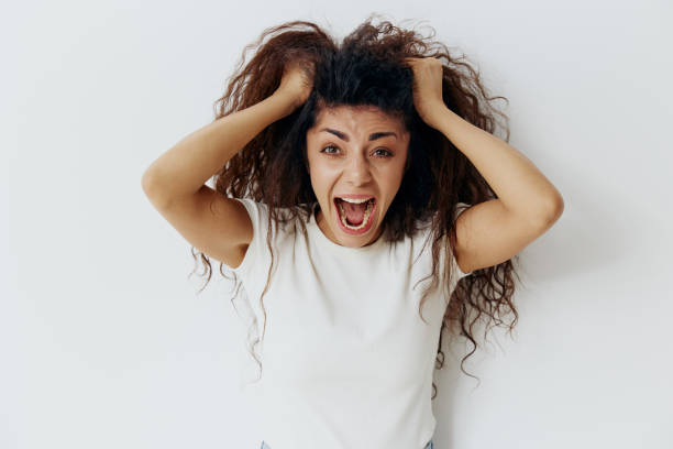 istock Panic Attack PROBLEMS CONCEPT. Crazy beautiful Latin female with afro rips out hair, have big troubles. Fashion. Studio shoot over white background. Copy space, free place for design ad. 2148643976
