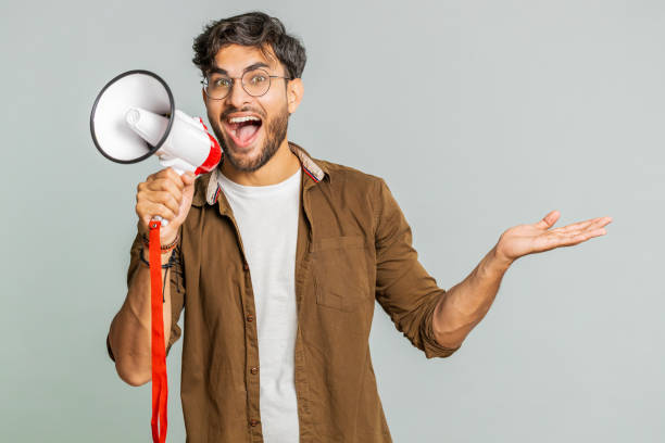 istock Indian man talking with megaphone, proclaiming news, loudly announcing advertisement discounts sale 2148644158