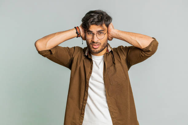 istock Annoyed irritated Indian man covering ears gesturing no avoiding advice ignoring noise loud voices 2148644161