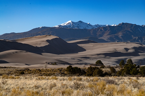 Sand dunes and mountain range at Great Sand Dunes National Park in Colorado, USA