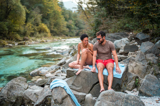 istock Mid Adult Multiracial Couple Flirting While On An Outdoors River Date 2148647750