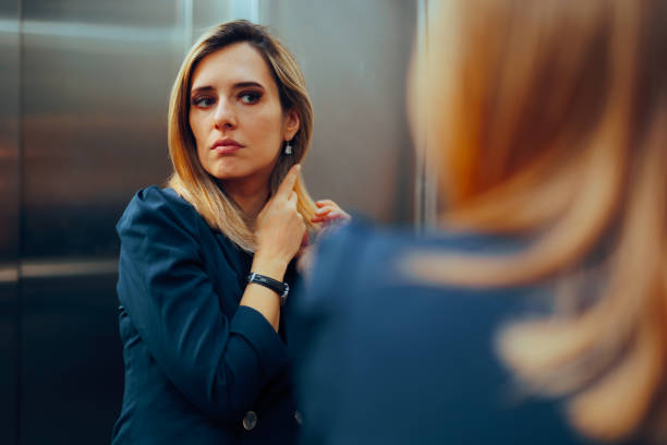 istock Professional Woman Arranging her Hair in an Elevator Mirror 2148648137